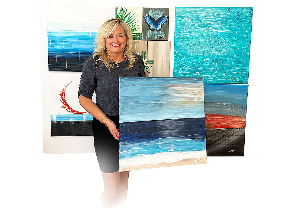 Amy Schultz with several of her paintings
