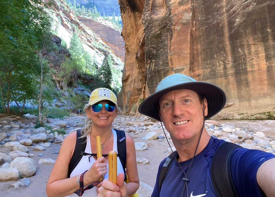 Amy and her husband hiking the Narrows in Zion National Park